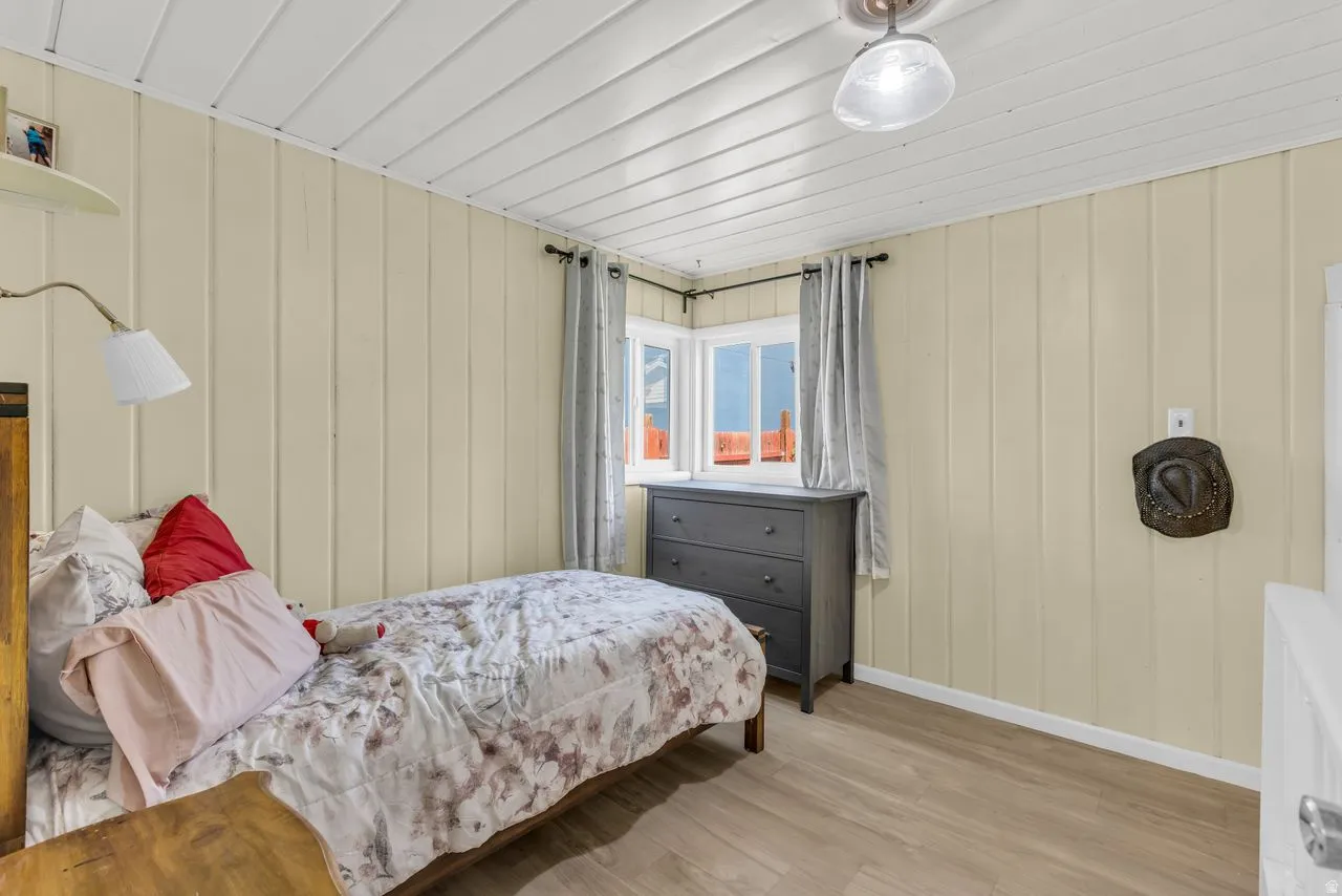 Bedroom featuring wood finished floors and baseboards