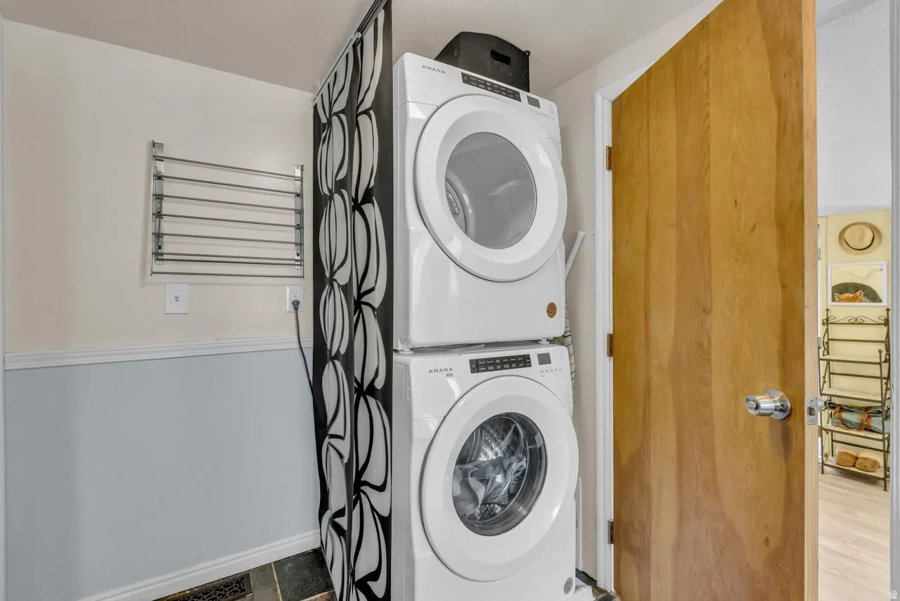 Laundry area featuring baseboards and stacked washer / drying machine