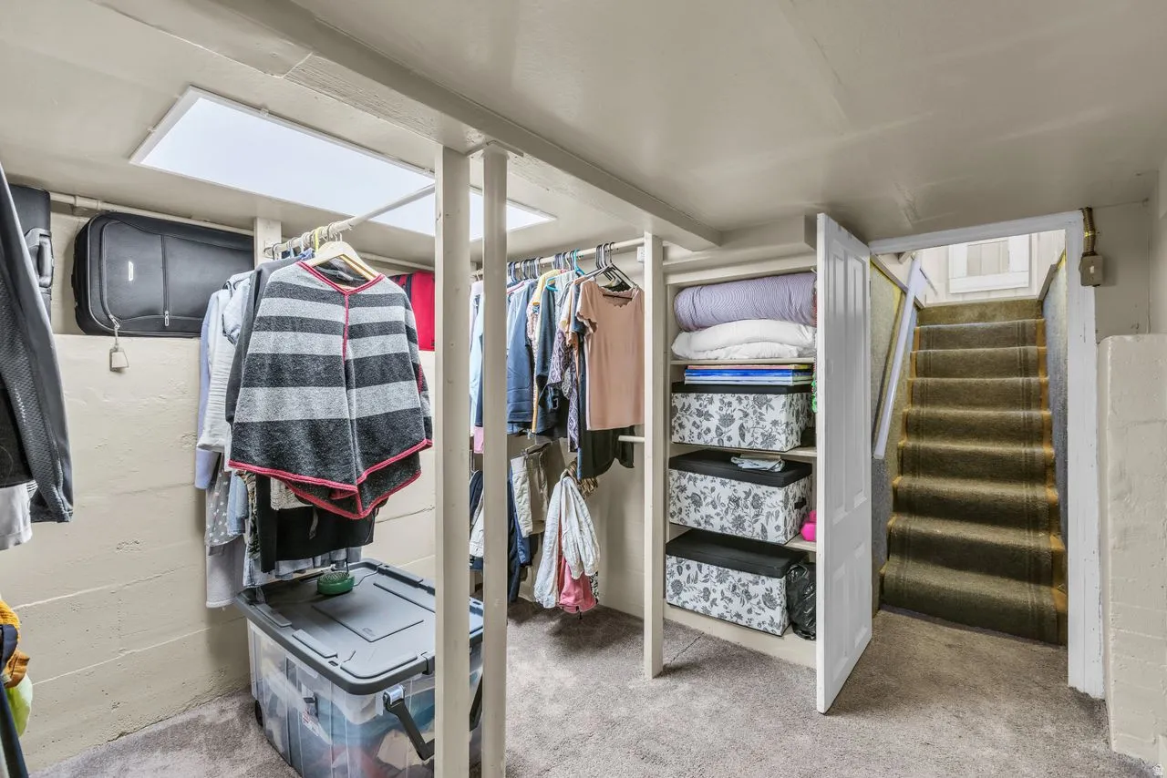 Walk in closet featuring light carpet