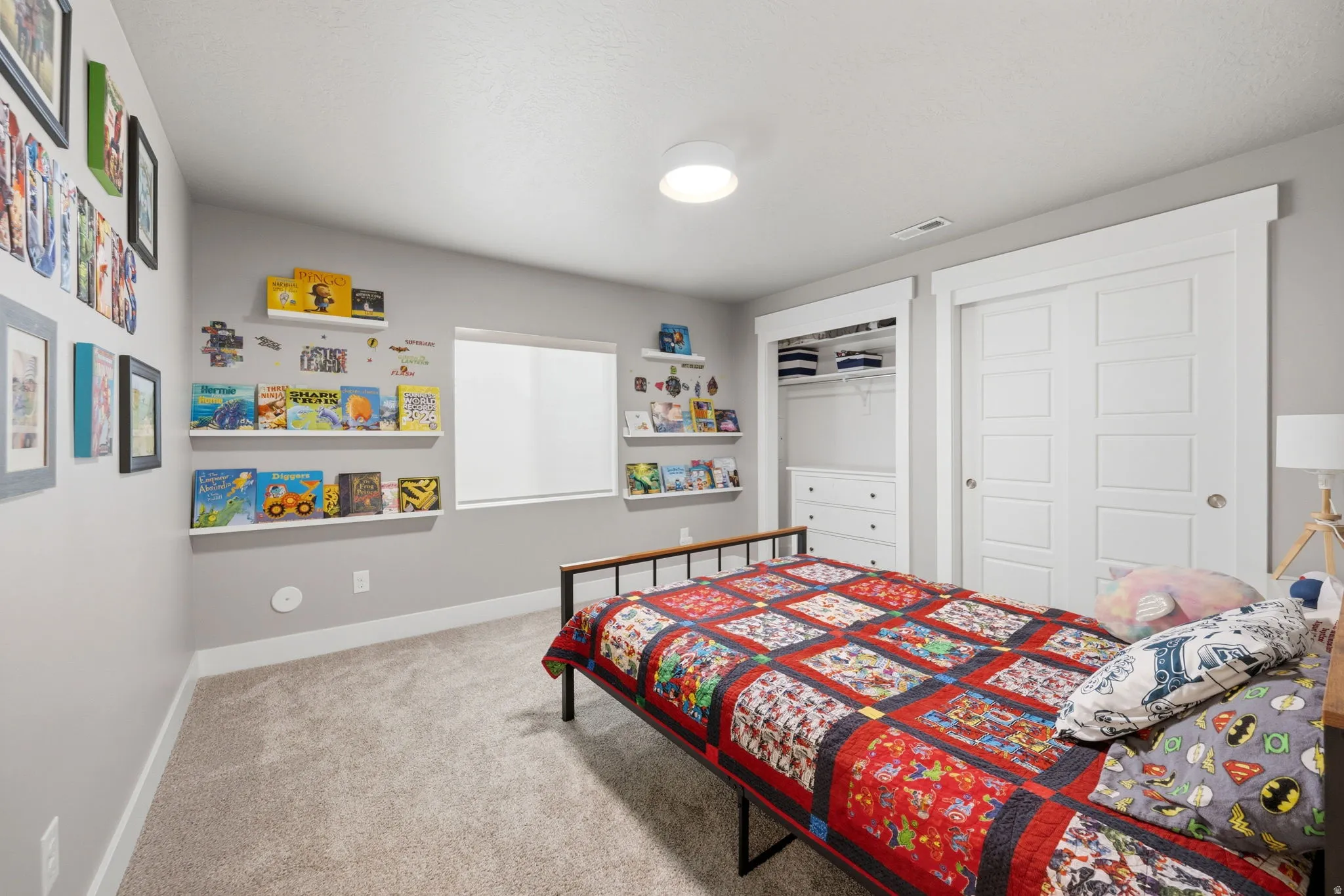 Bedroom featuring light carpet and a closet