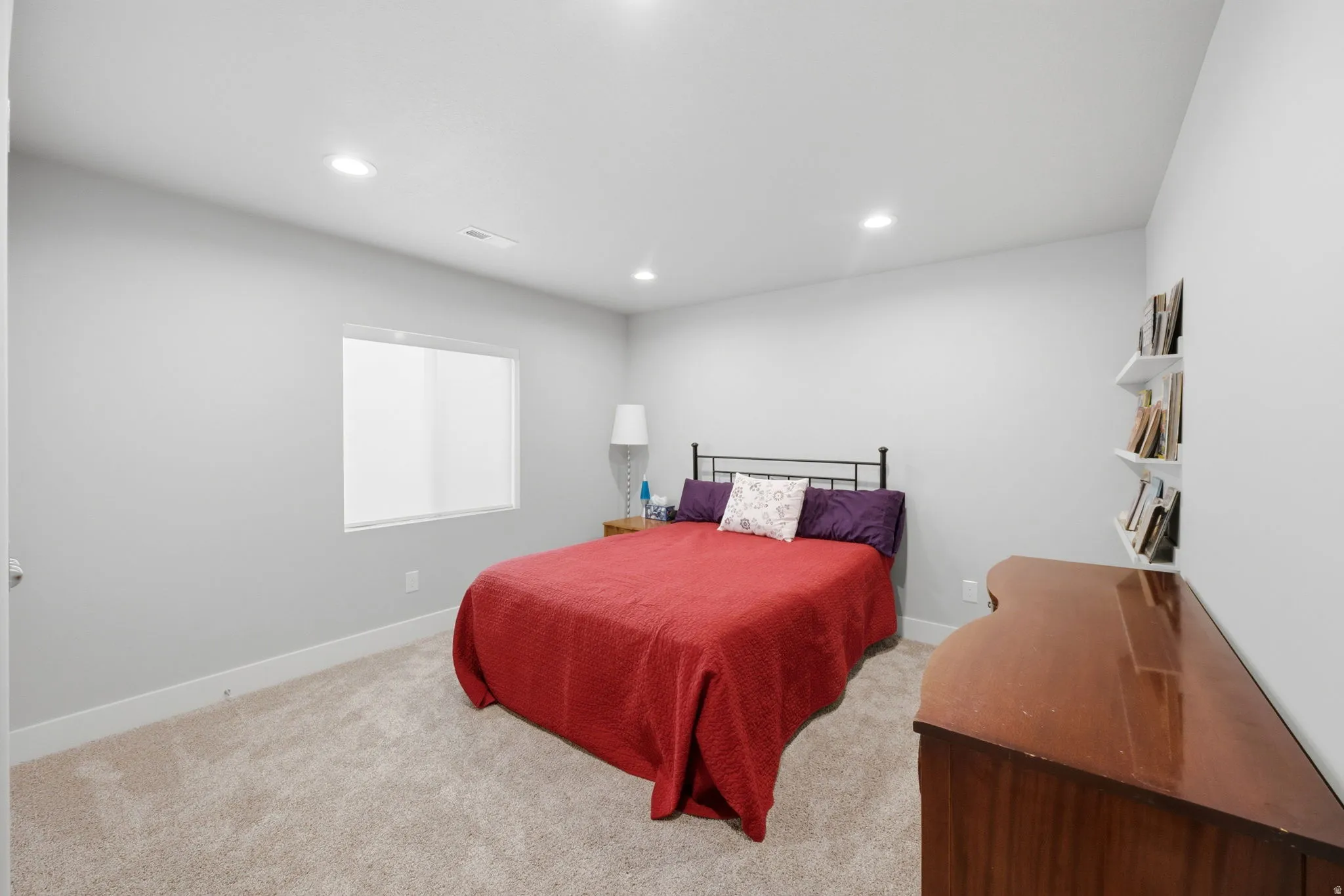 Bedroom with recessed lighting and light carpet