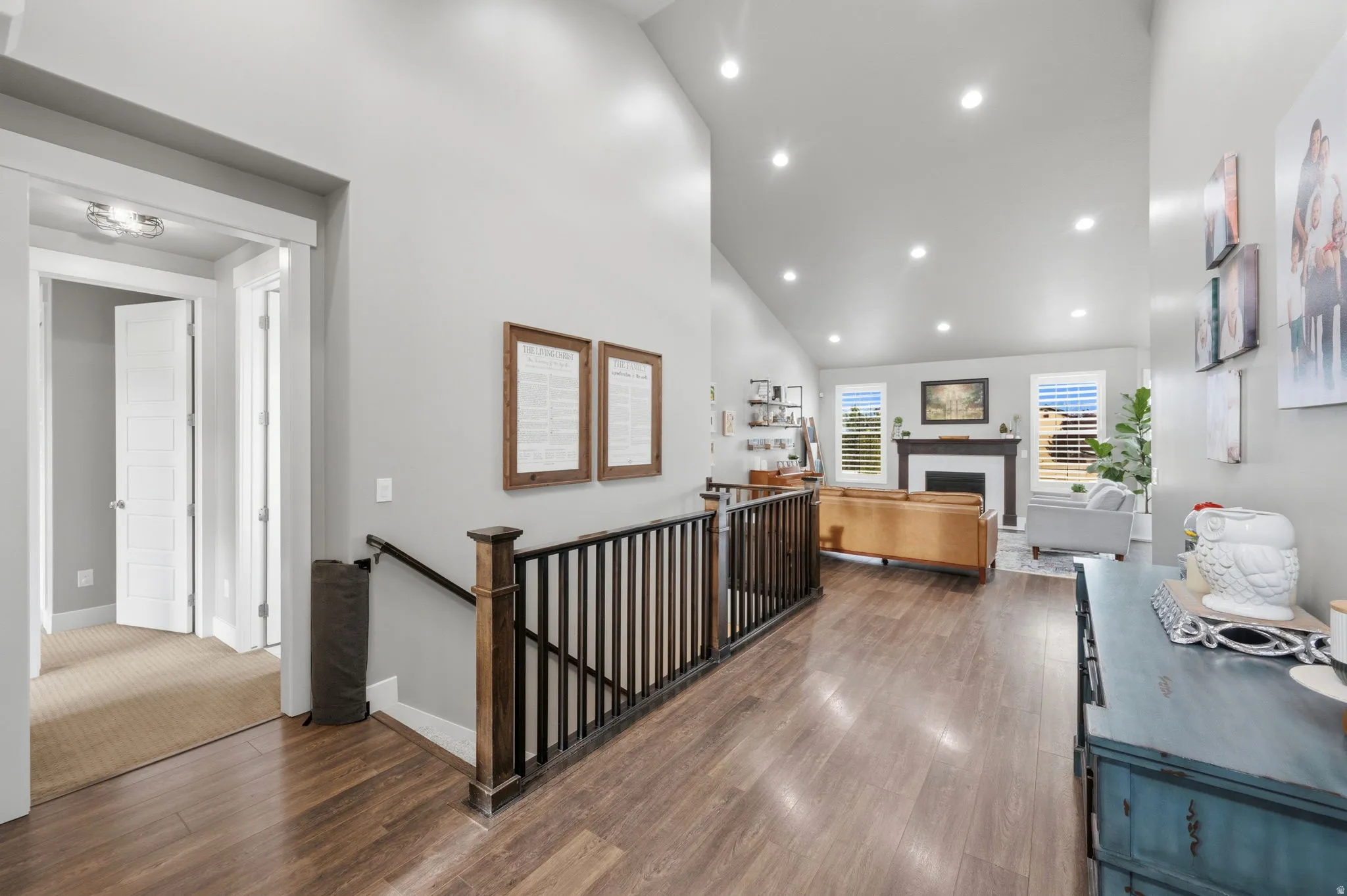 Corridor featuring an upstairs landing, vaulted ceiling, dark wood finished floors, and recessed lighting