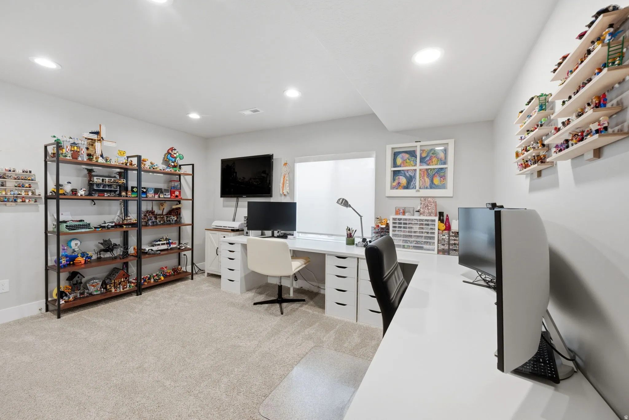Office area with light colored carpet and recessed lighting