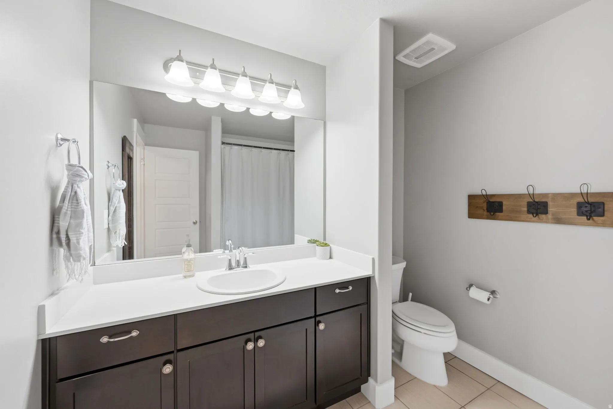 Full bathroom featuring vanity, light tile patterned floors