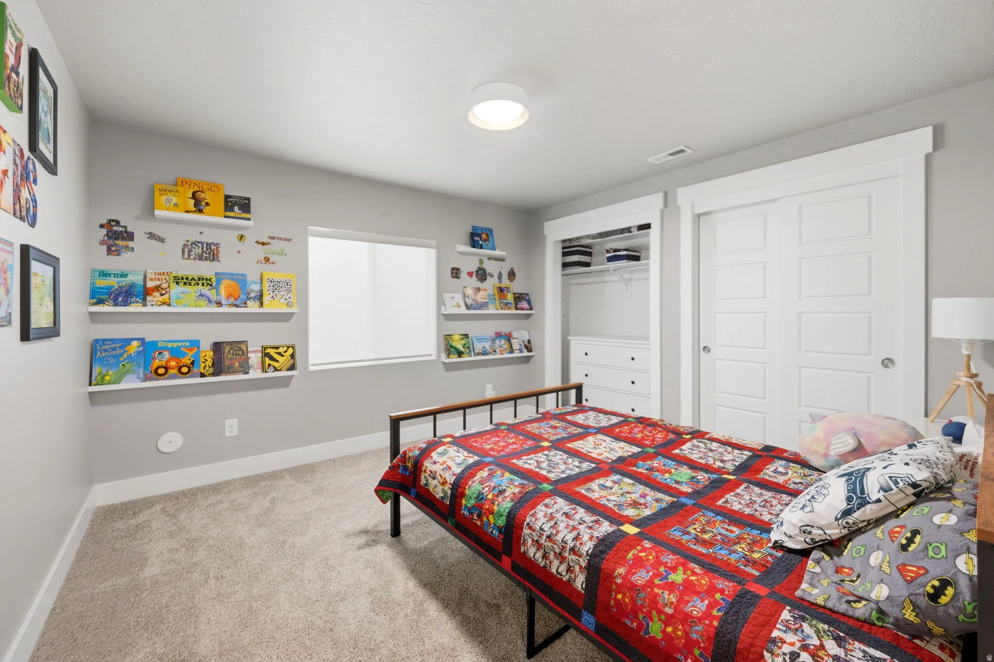 Bedroom with a closet and light carpet