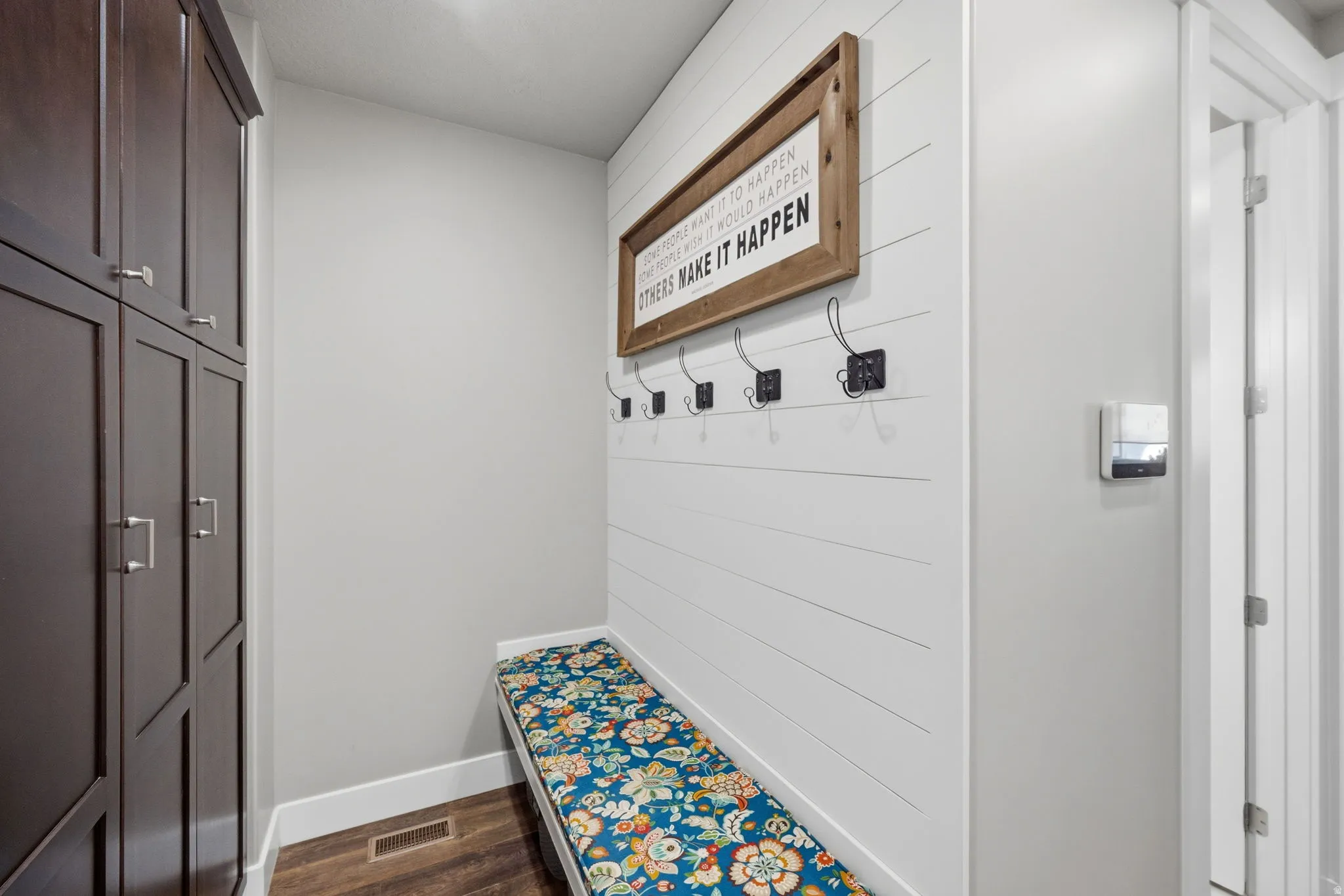 Mudroom with dark wood-style floors and baseboards