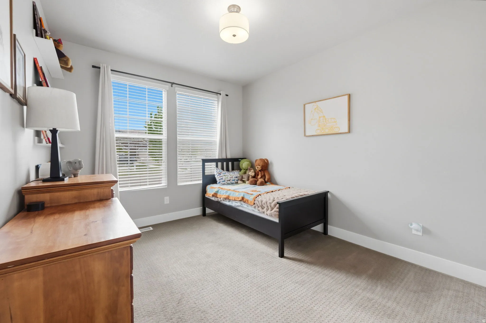 Bedroom with light carpet and baseboards