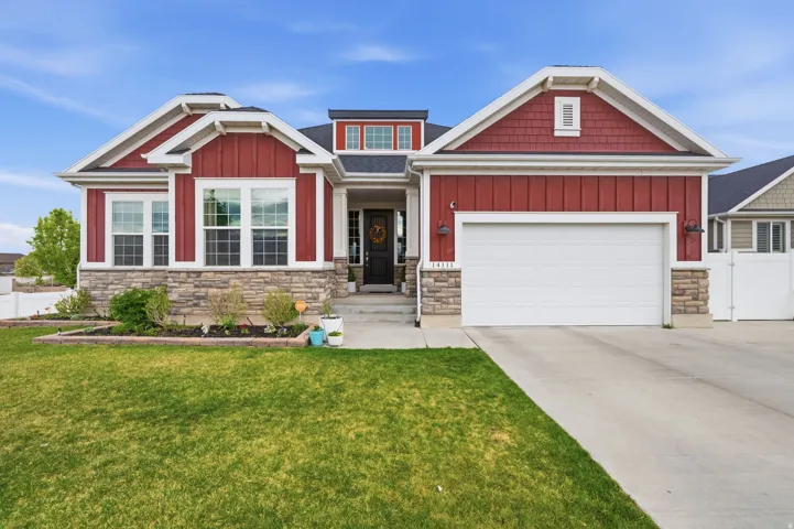 Exterior featuring stone siding, board and batten siding, concrete driveway, and a garage