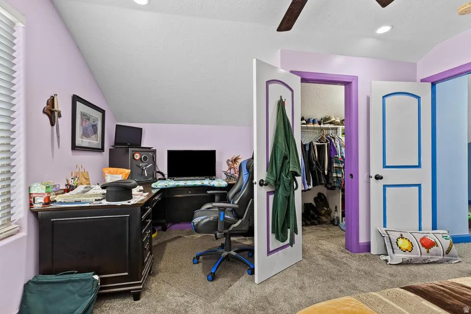 Office area with light carpet and a ceiling fan