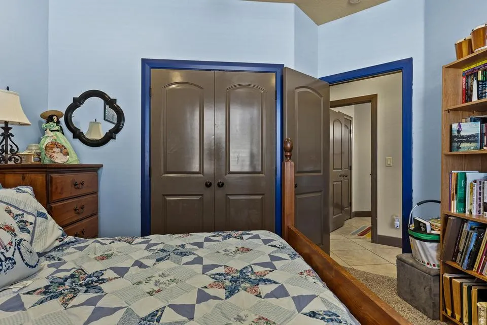 Bedroom with a closet and light tile patterned flooring