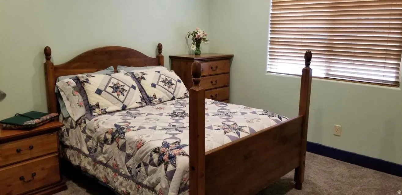 Carpeted bedroom with baseboards