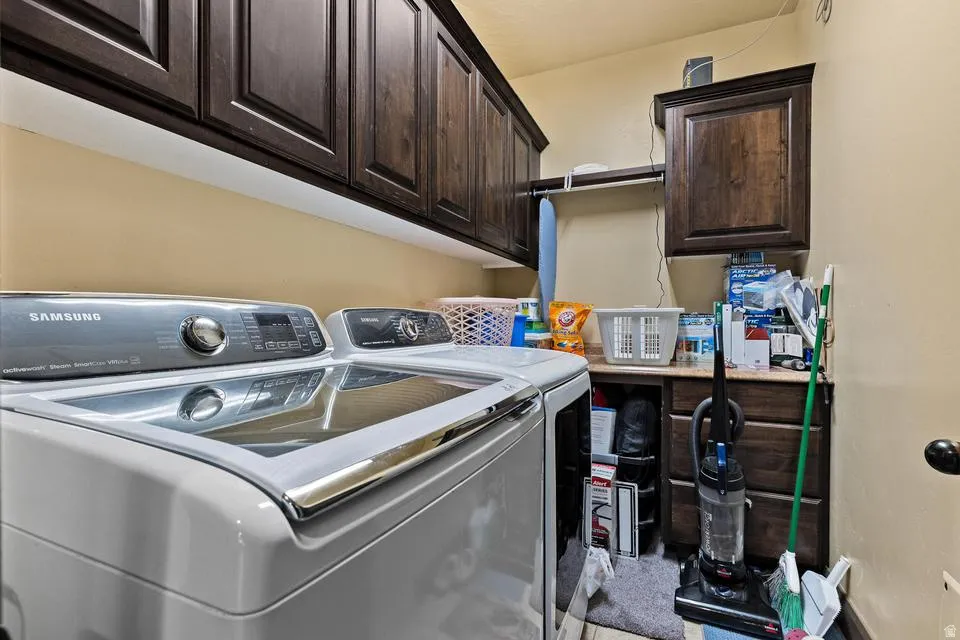 Laundry room featuring cabinet space and washing machine and clothes dryer