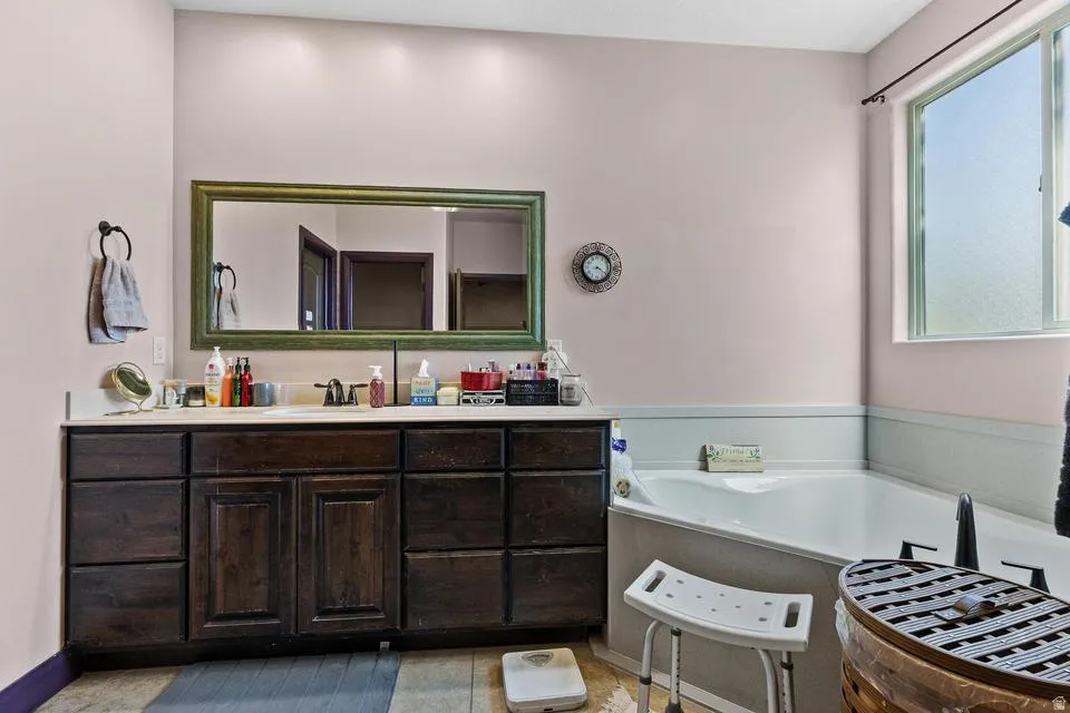 Full bathroom with vanity and a bath