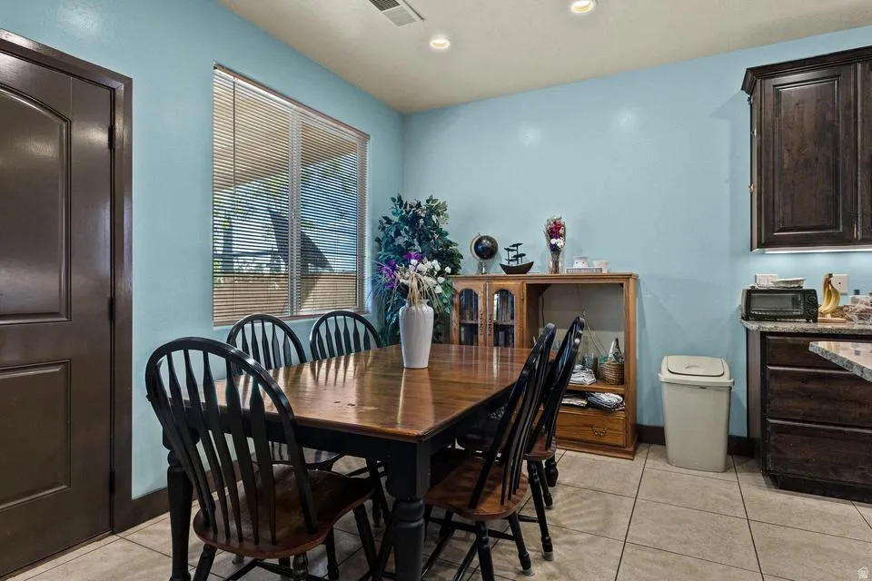 Dining area featuring light tile patterned floors and recessed lighting