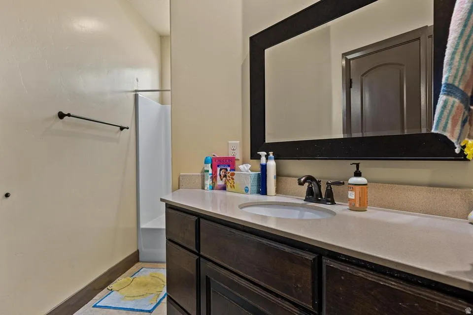 Full bathroom featuring vanity and shower / bath combination