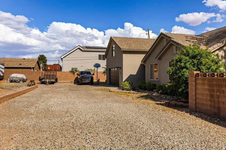 View of yard with gravel driveway and a garage