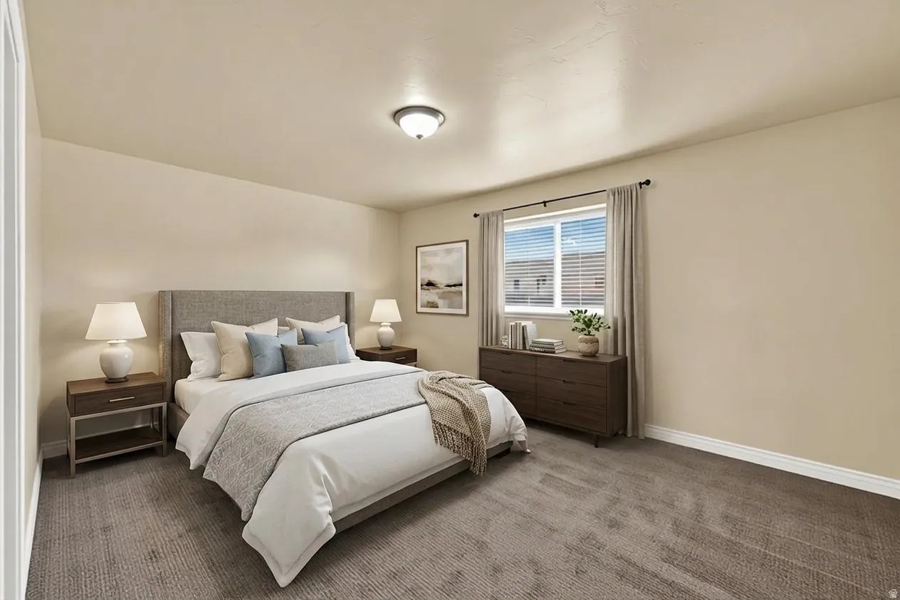 Carpeted bedroom featuring baseboards
