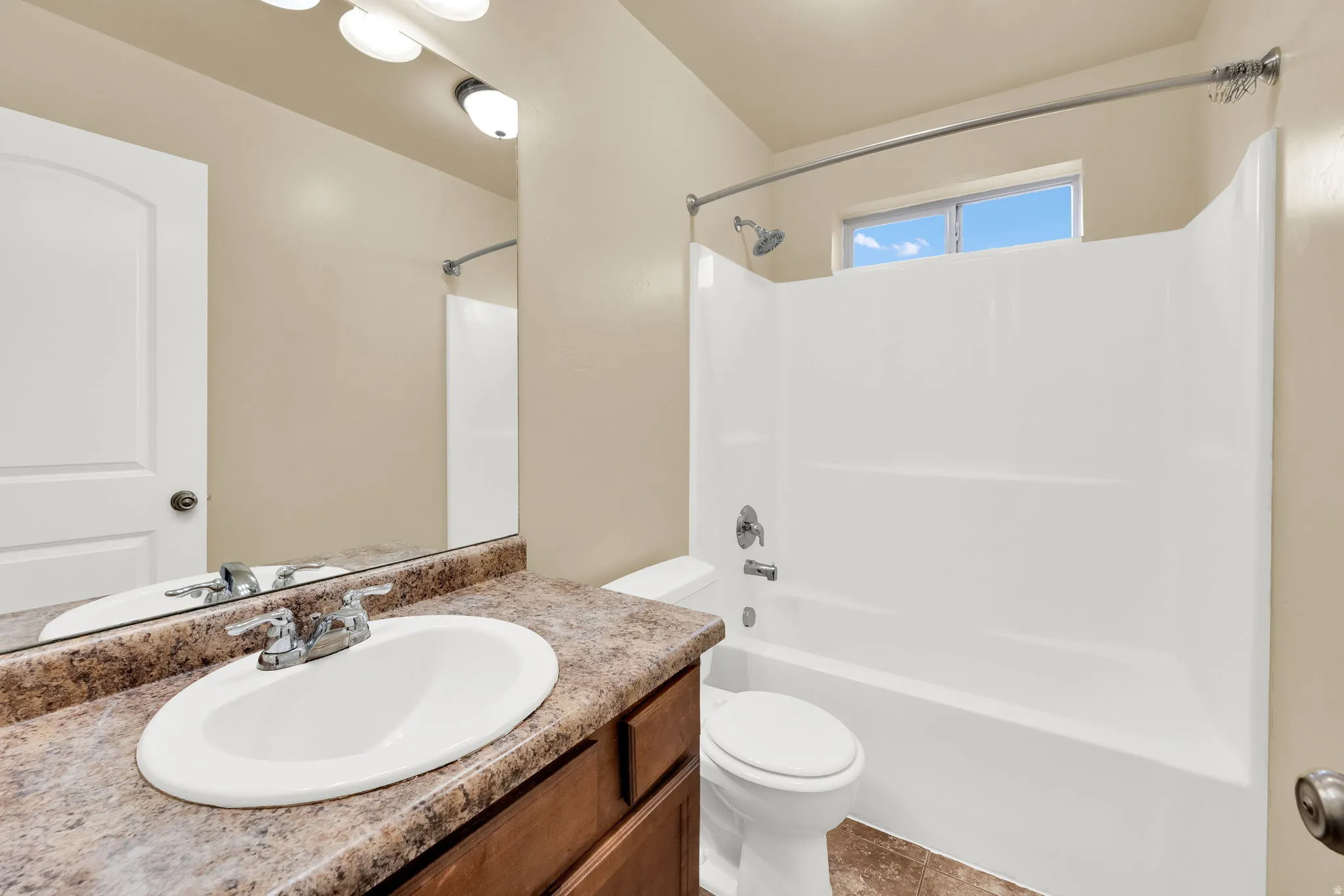 Full bath featuring vanity and  shower combination