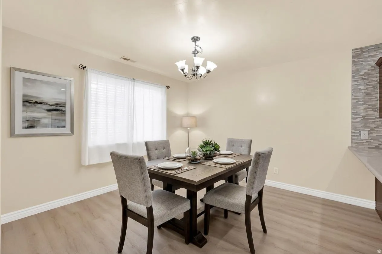 Dining room featuring light wood-style floors and suspended lighting