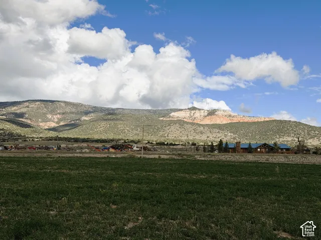 Expansive open acreage featuring mountain terrain and prominent rock formations