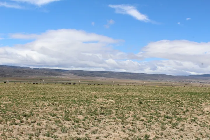 View of mountain backdrop featuring rural landscape