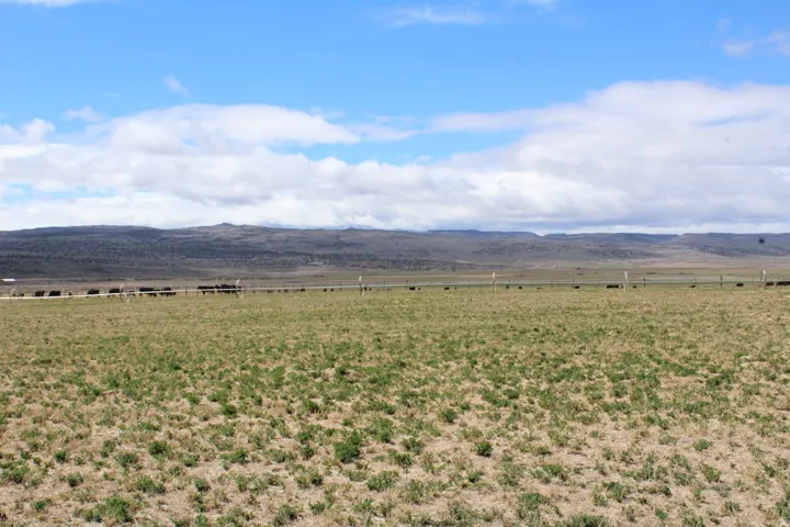 View of mountain backdrop with rural landscape