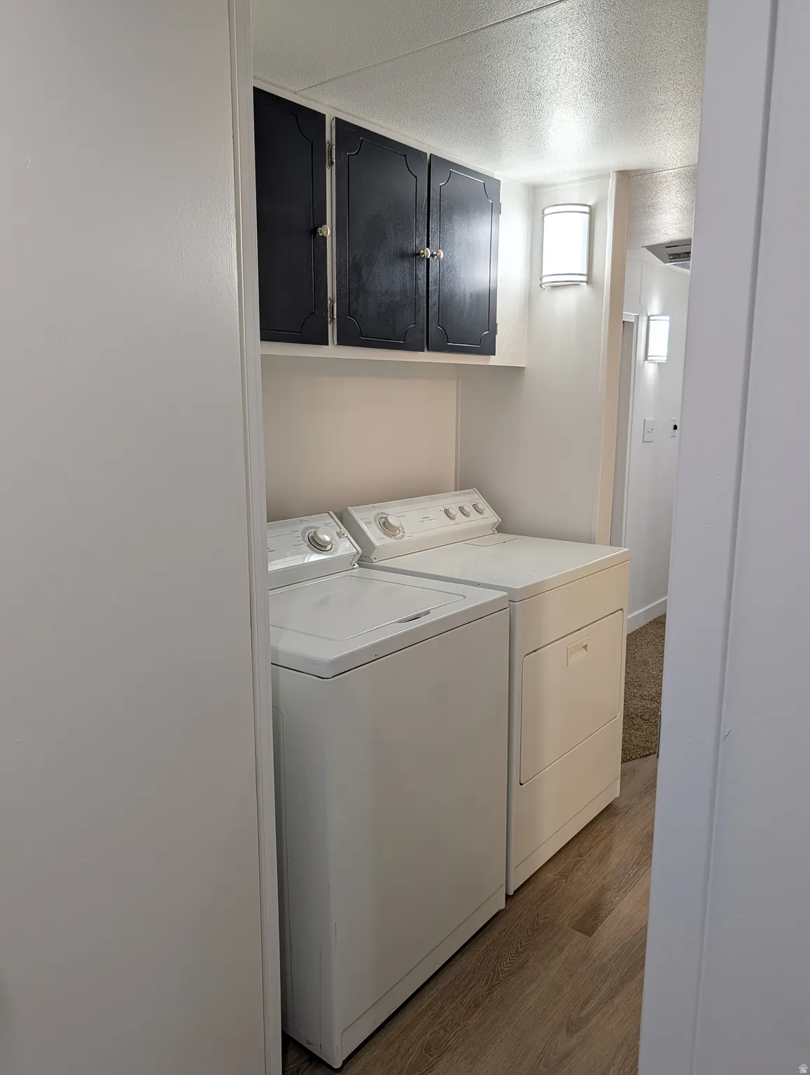 Laundry area with independent washer and dryer and cabinet space