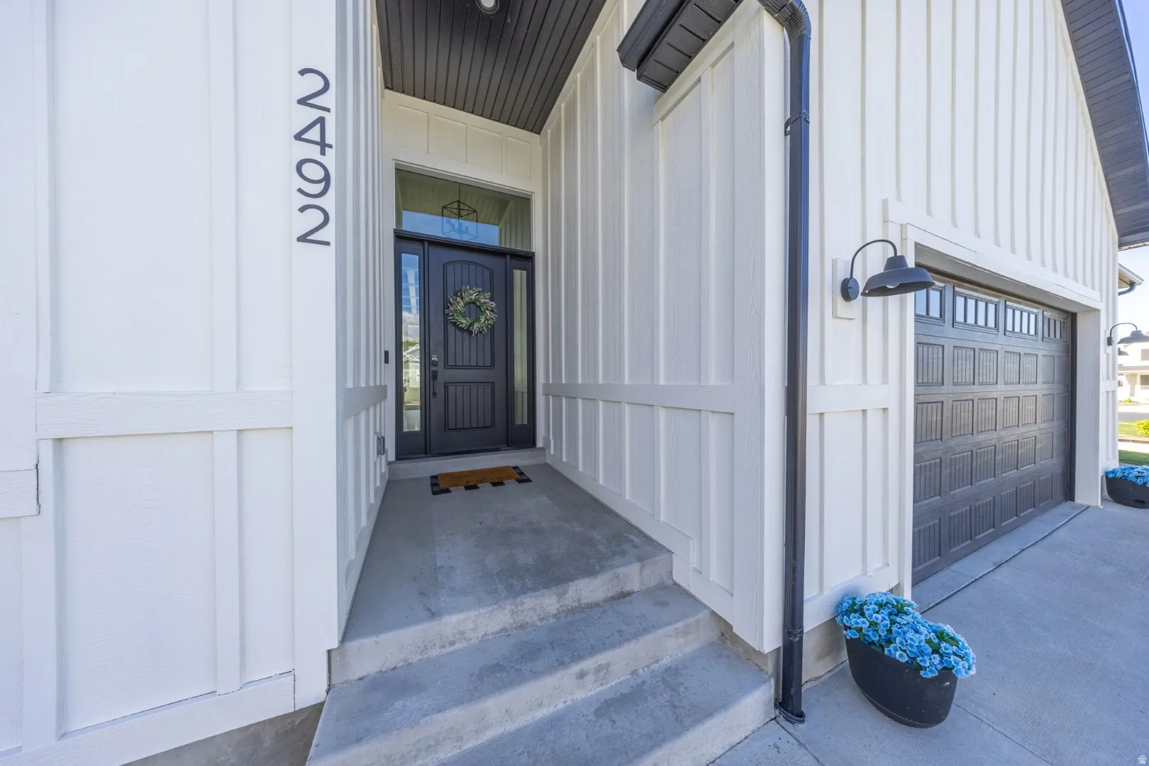 Doorway to property featuring board and batten siding and a garage