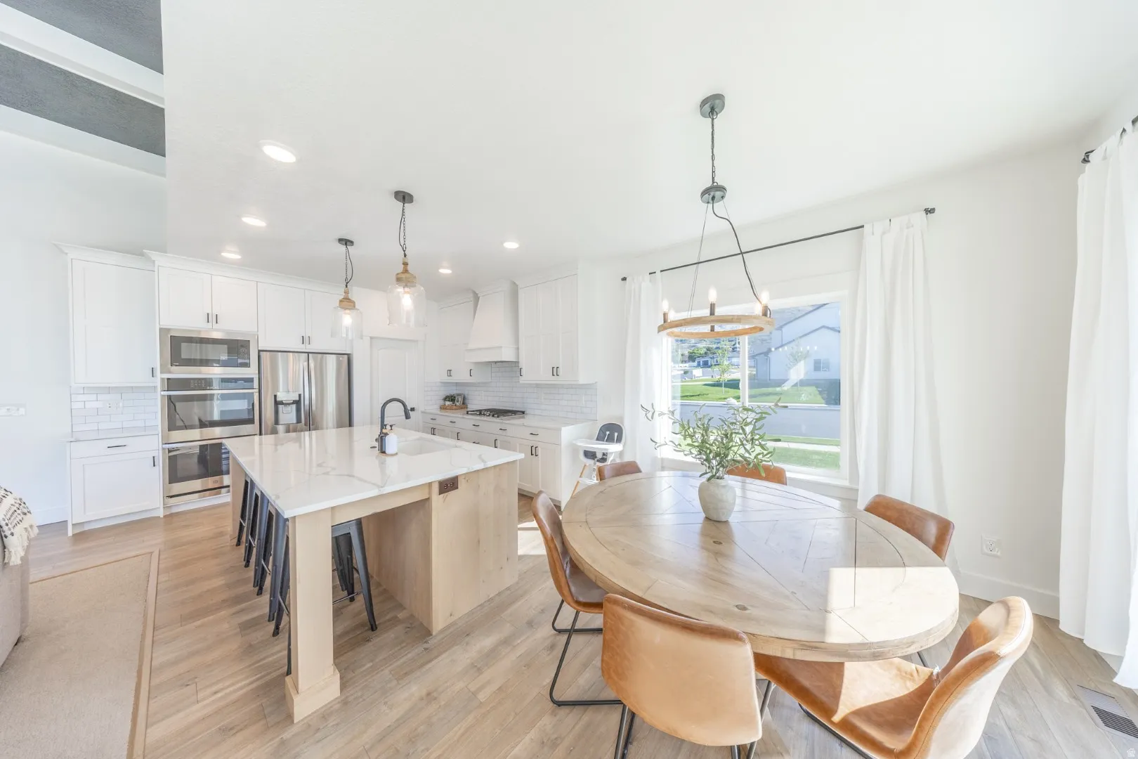 Dining space featuring light wood-type flooring and hanging lights