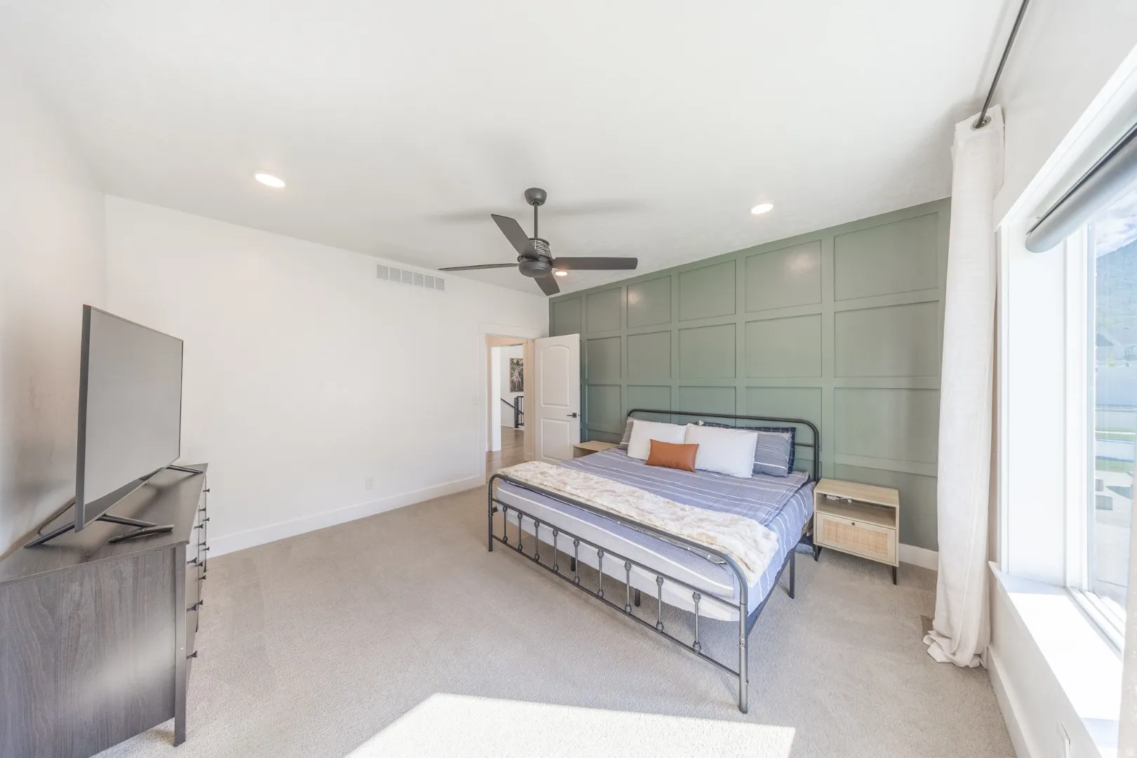 Bedroom with a decorative wall, a ceiling fan, light colored carpet, recessed lighting, and an accent wall