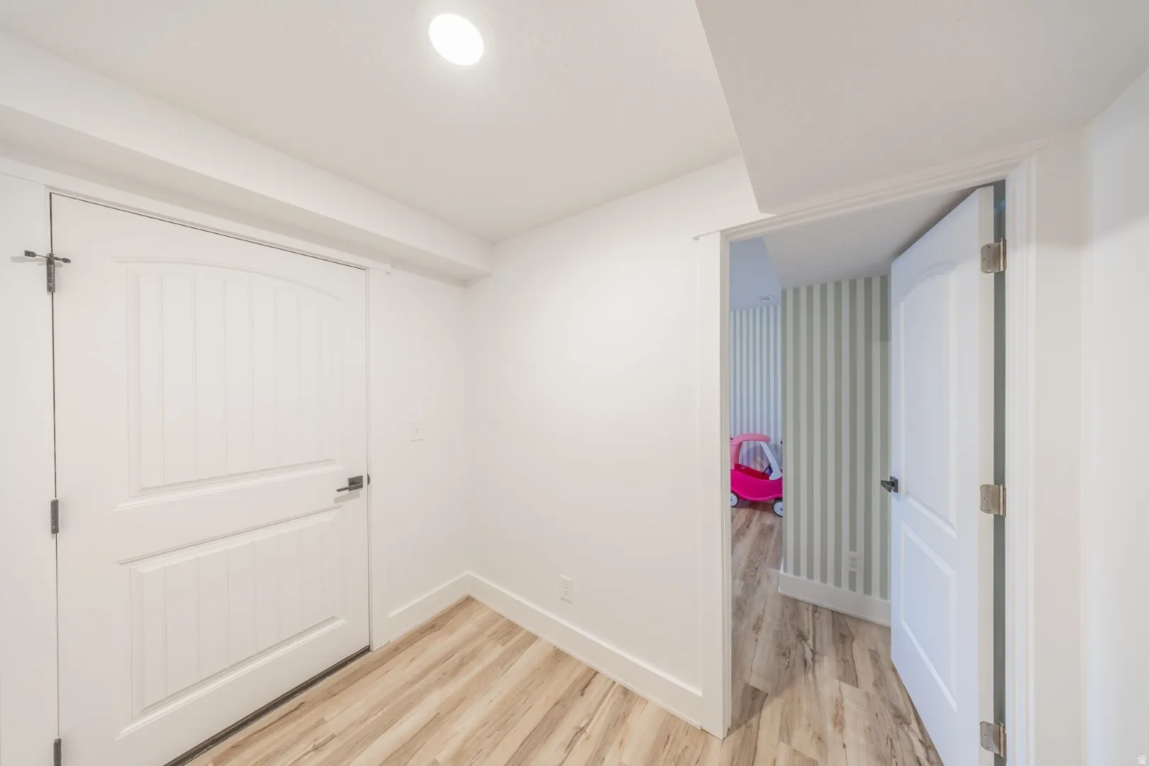 Unfurnished bedroom with light wood finished floors