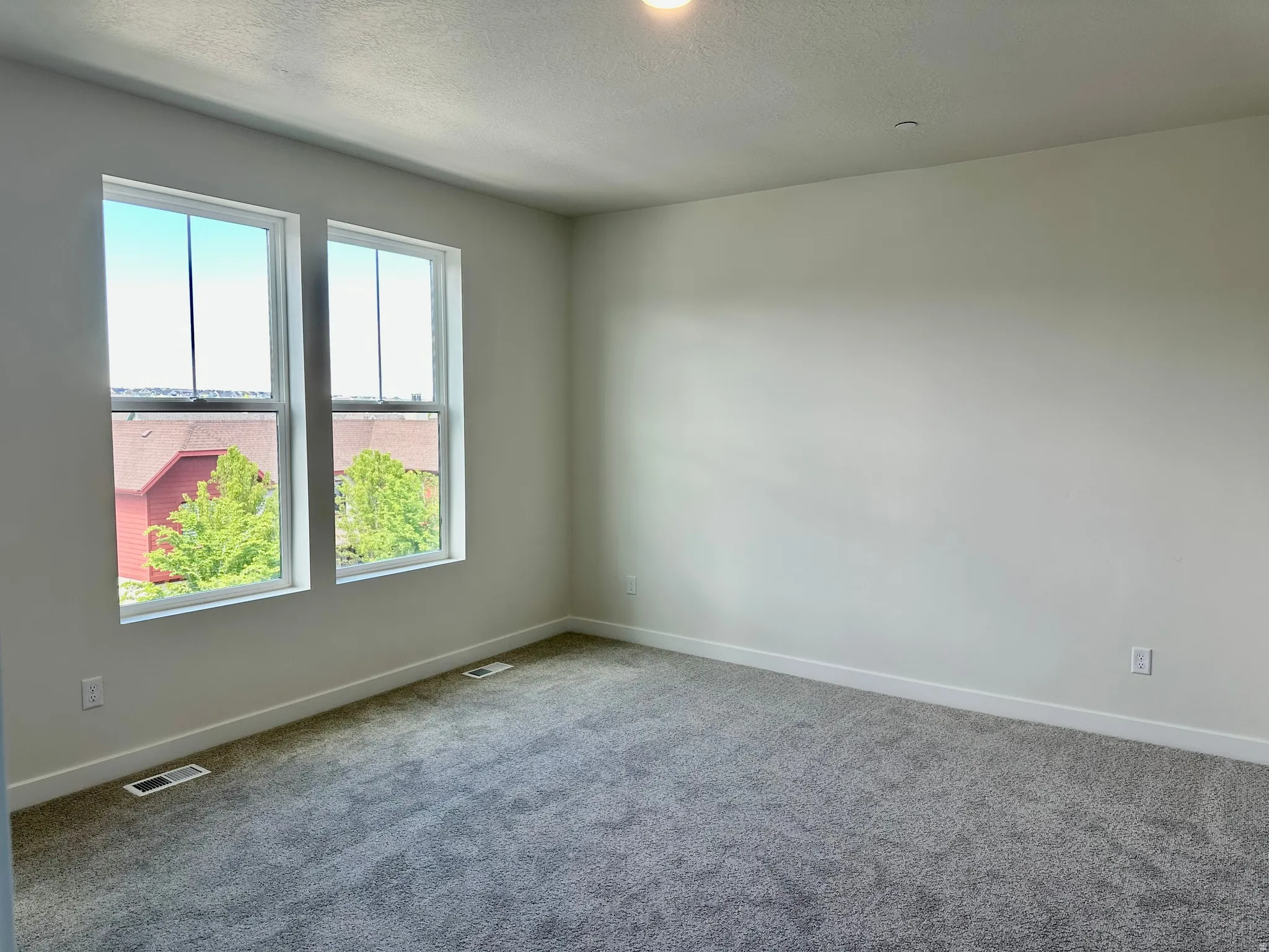 Owner's retreat with large windows that let in lots of natural light