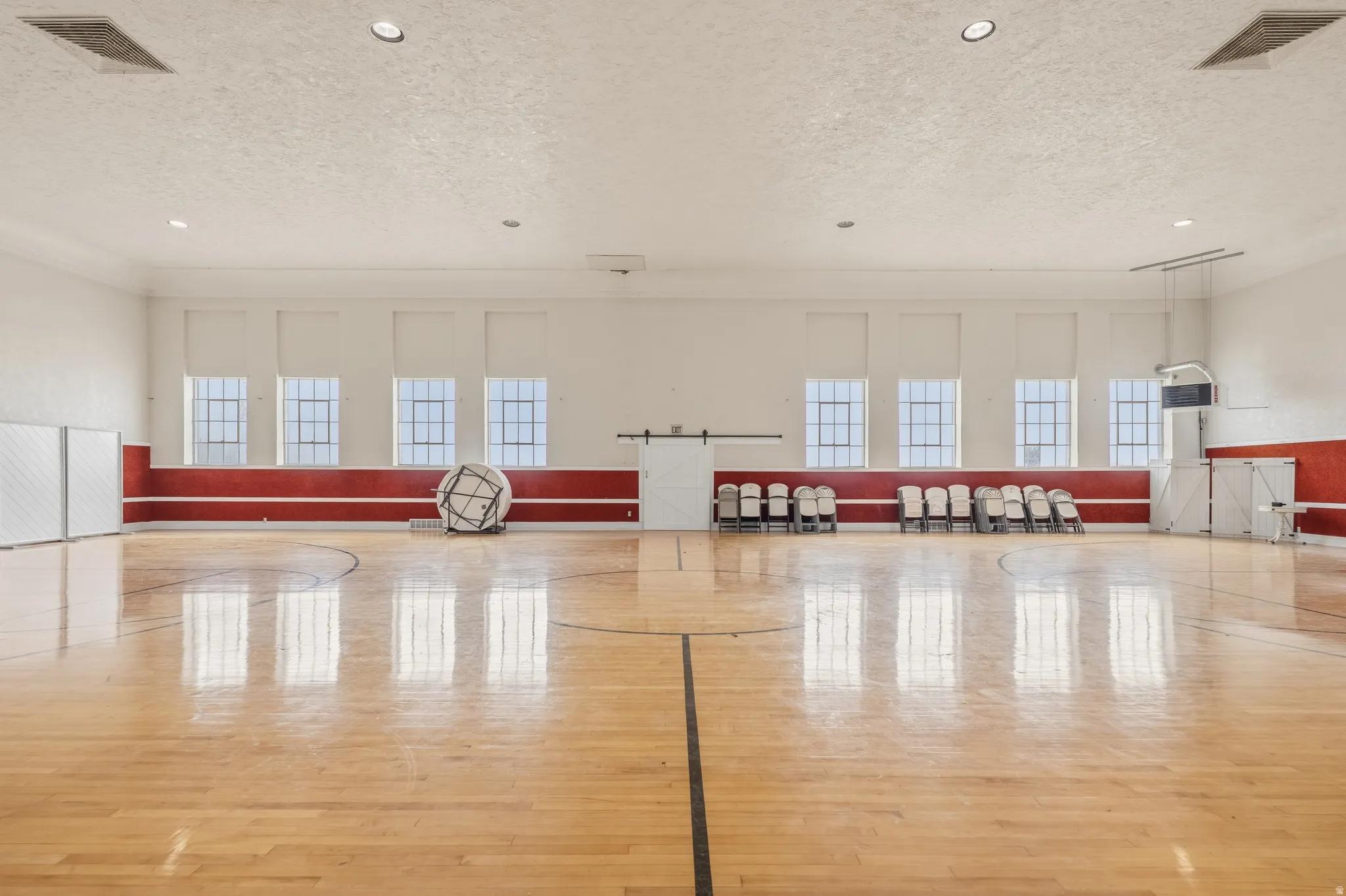 View of basketball court featuring community basketball court and healthy amount of natural light