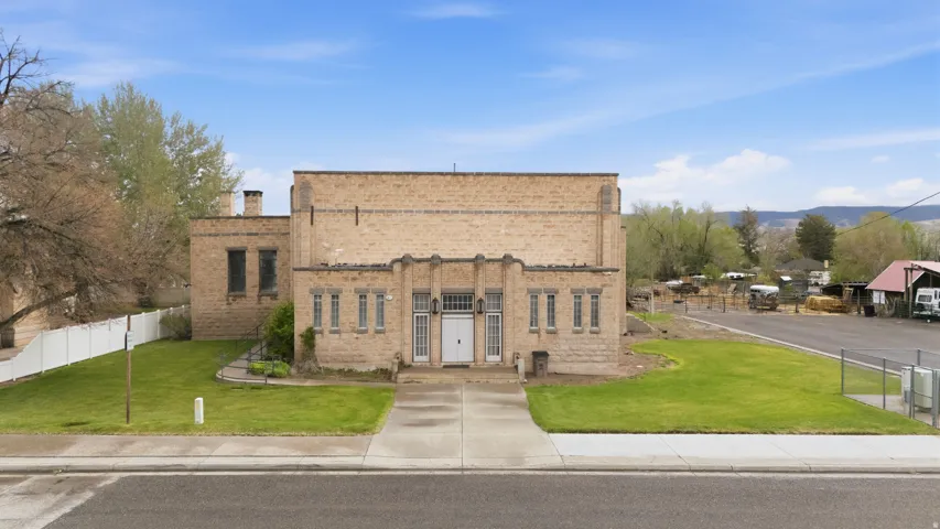 View of front of home featuring brick siding, a chimney, and a mountain view
