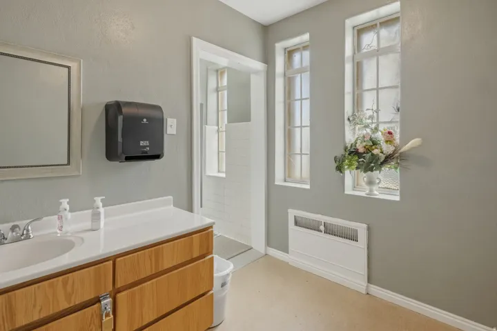 Full bathroom featuring tiled shower and vanity