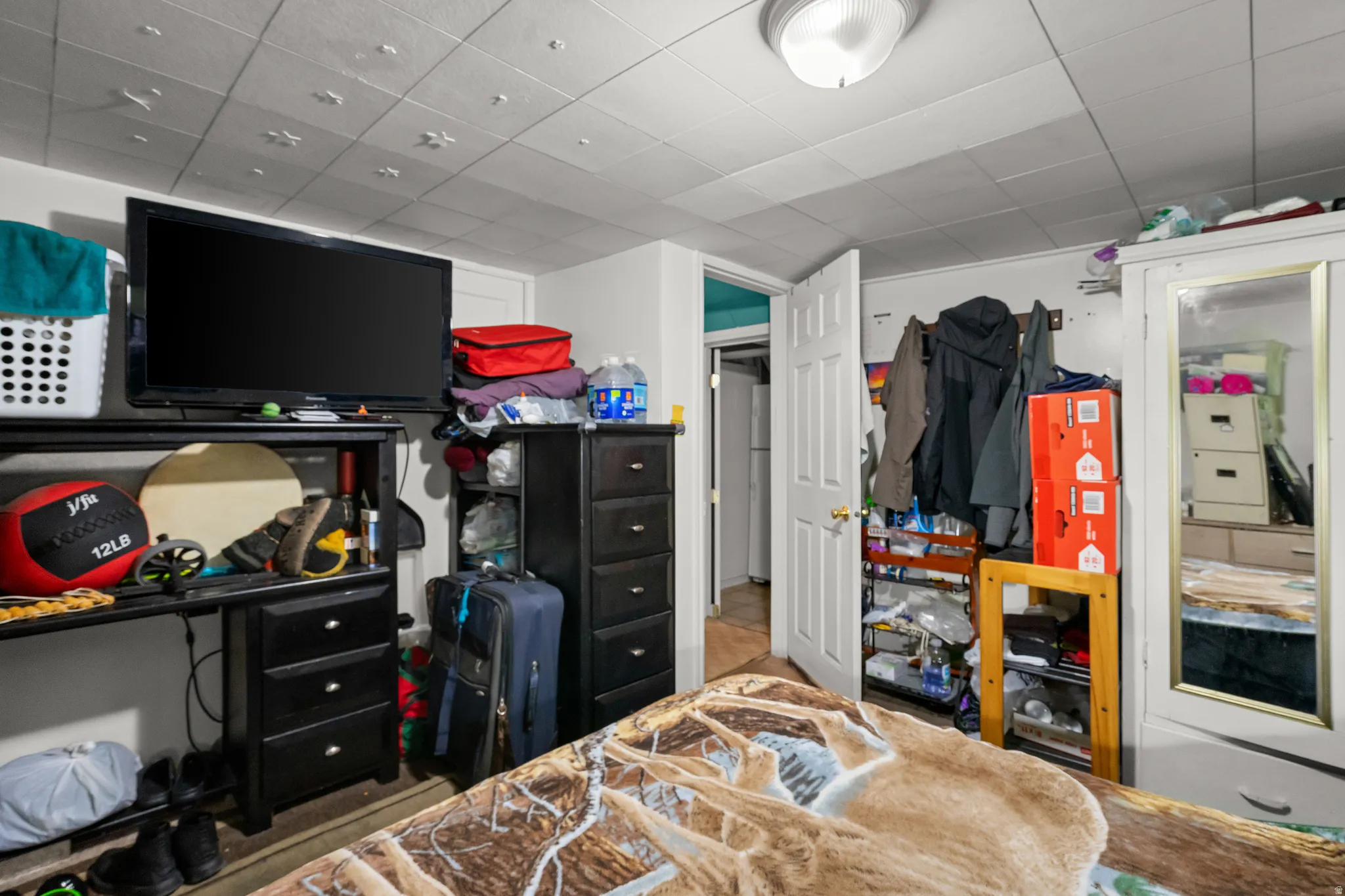 Bedroom featuring a paneled ceiling and a closet