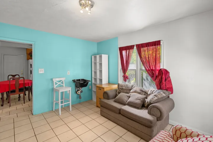 Living room featuring light tile patterned floors and baseboards