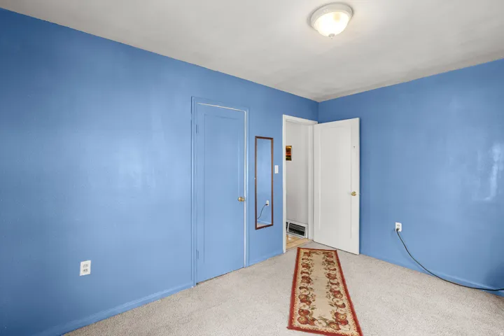 Unfurnished bedroom with carpet and baseboards