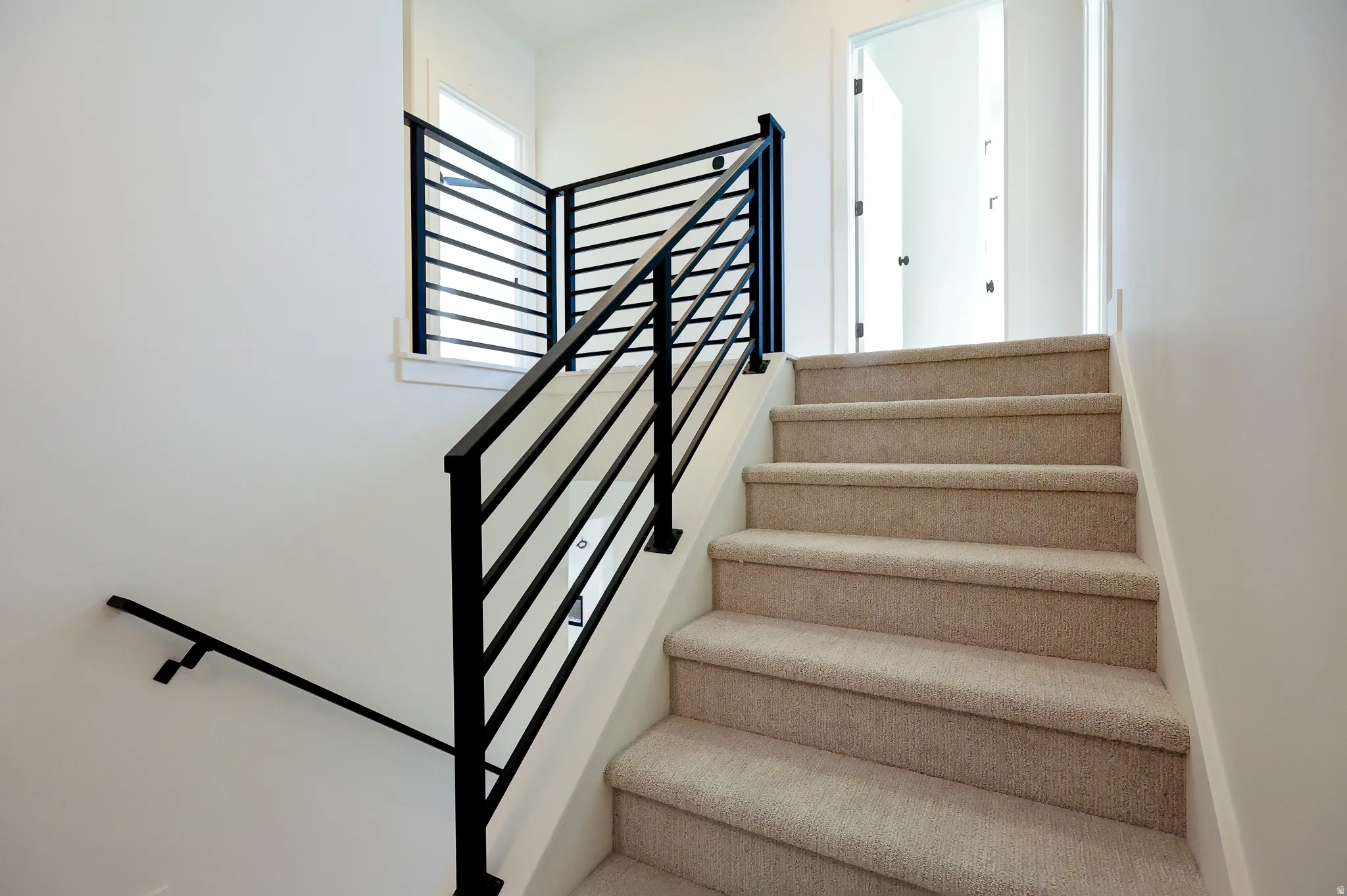 View of stairway with metal railing