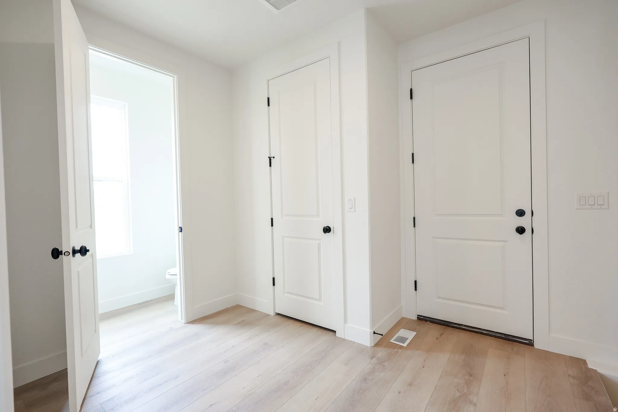 Entrance foyer with light wood-type flooring