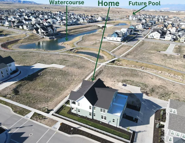 Aerial perspective of suburban area with a nearby watercourse