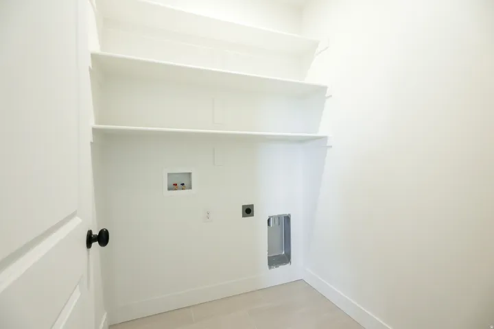 Laundry room with hookup for a washing machine and electric dryer hookup
