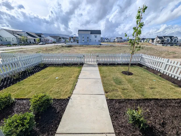 Fenced front yard with a residential view