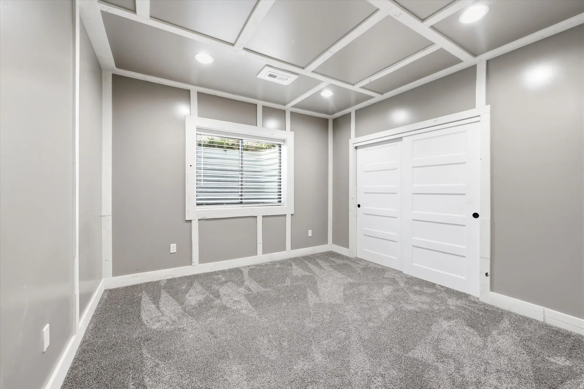 Spare room featuring light colored carpet and recessed lighting