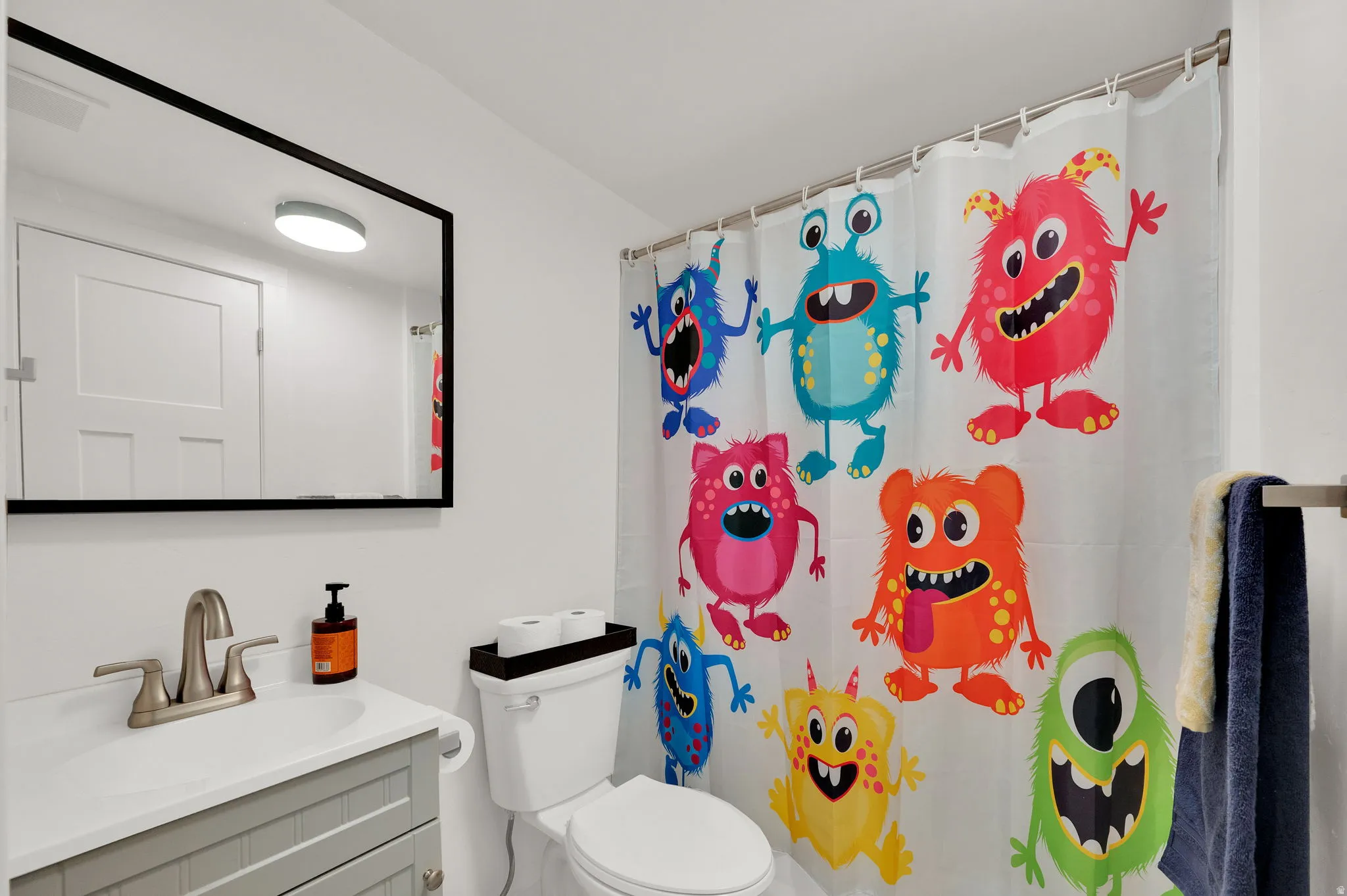 Bathroom with vanity and a shower with shower curtain