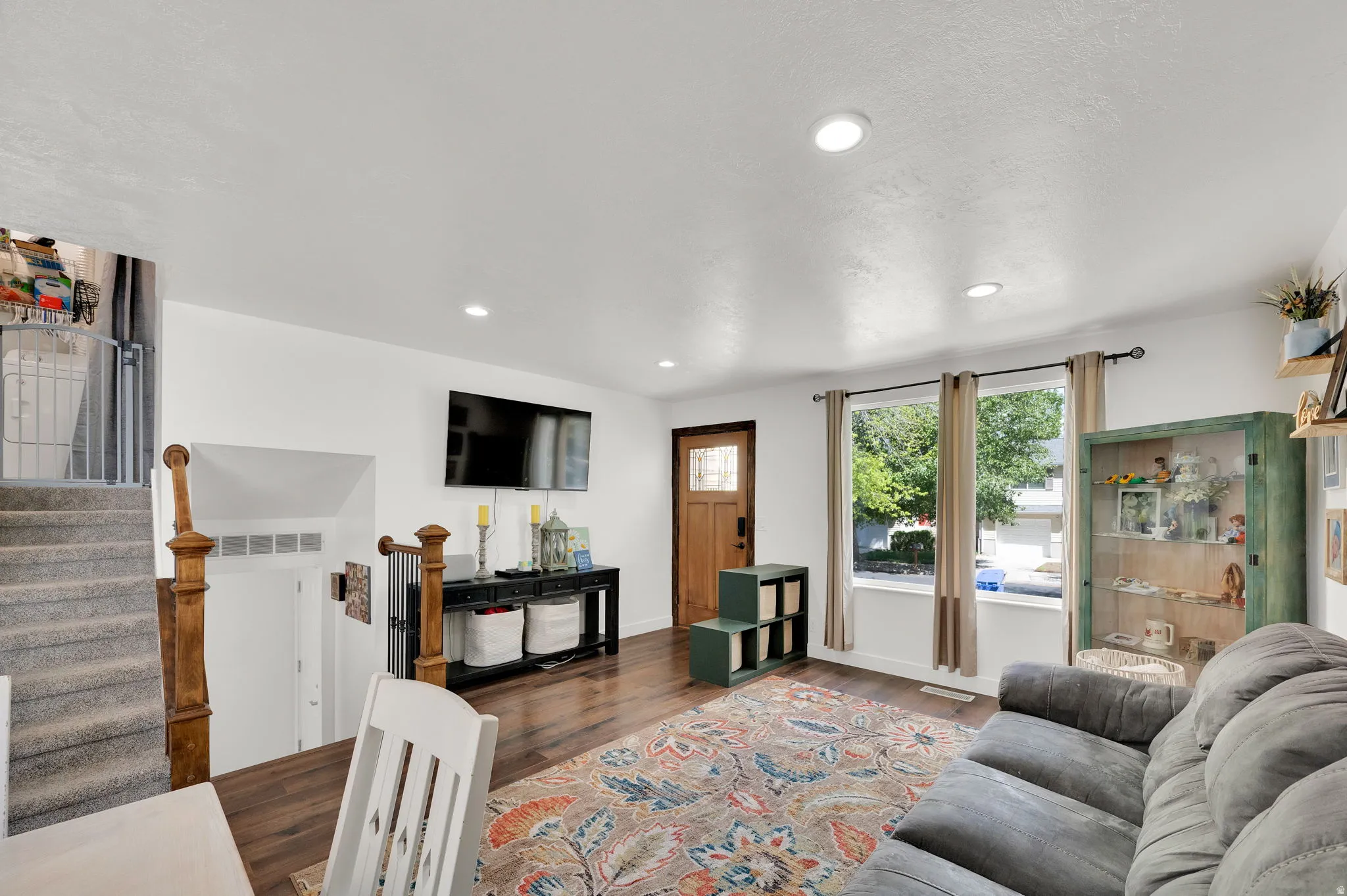 Living room featuring dark wood finished floors and recessed lighting