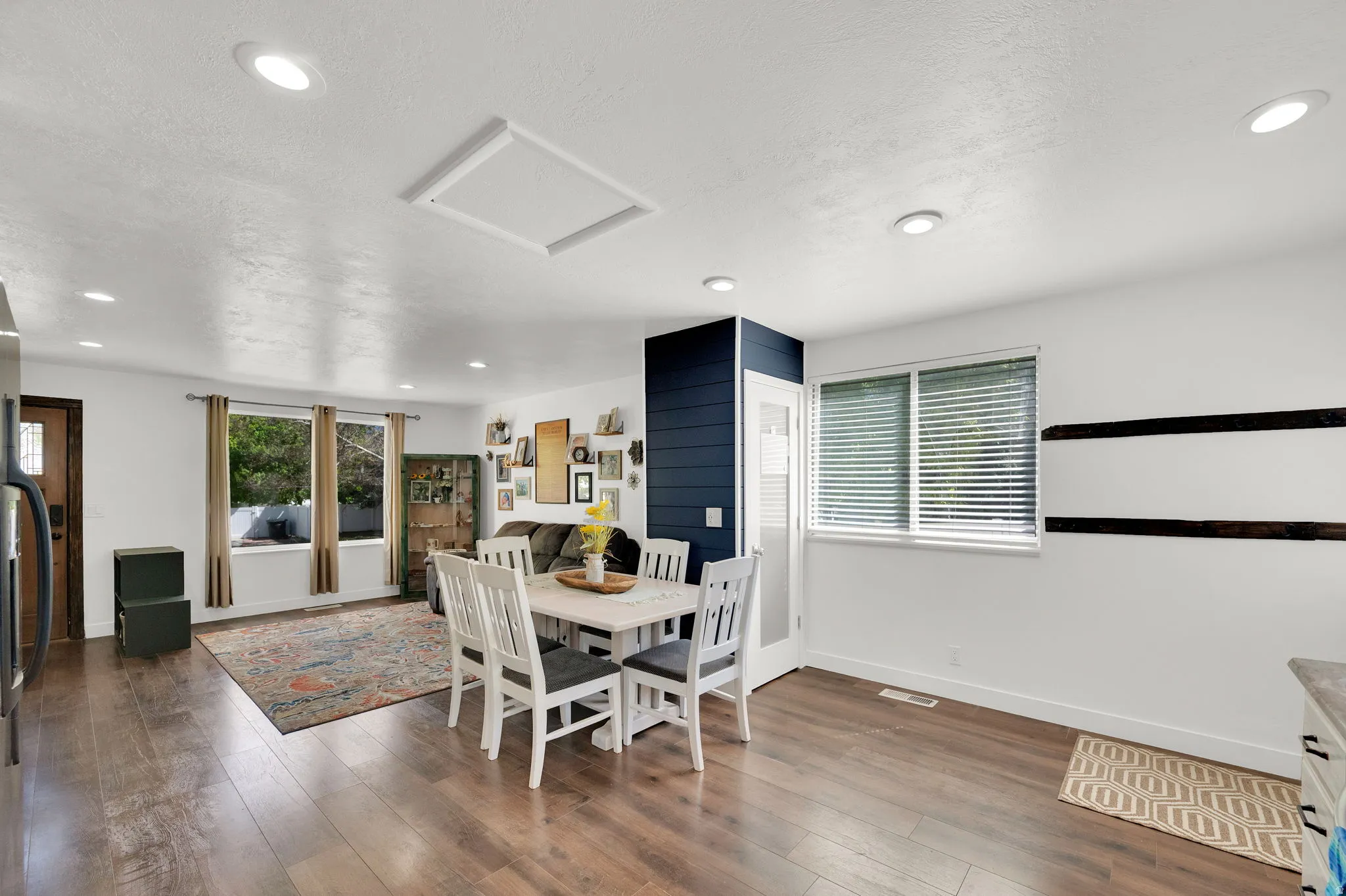 Dining space featuring dark wood-style flooring, healthy amount of natural light, and recessed lighting