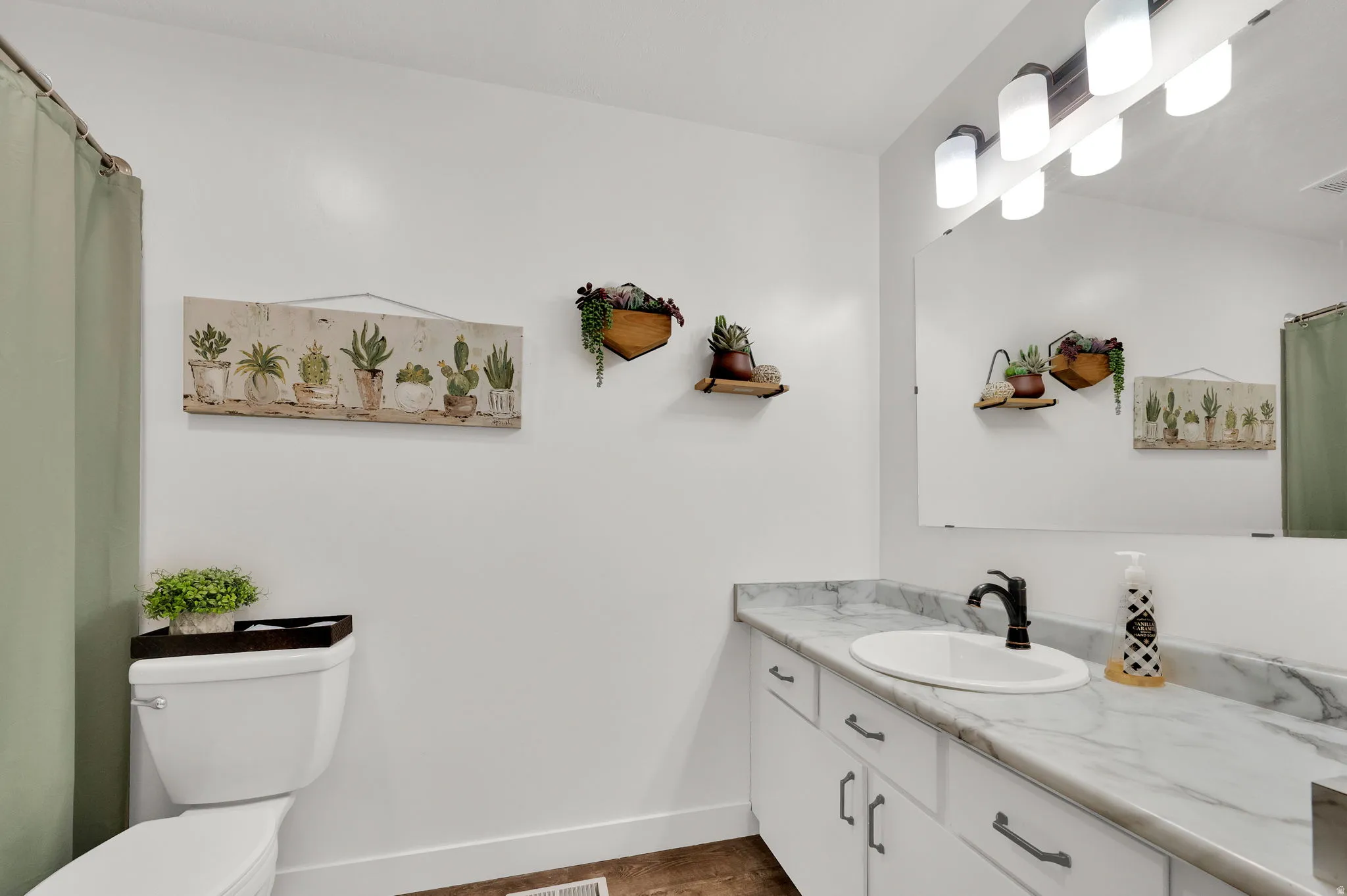 Bathroom with a shower with curtain, vanity, and dark wood-style flooring