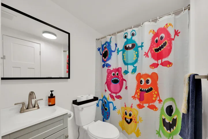 Bathroom with vanity and a shower with shower curtain