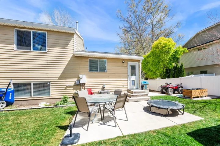 Rear view of property featuring a patio and outdoor dining area